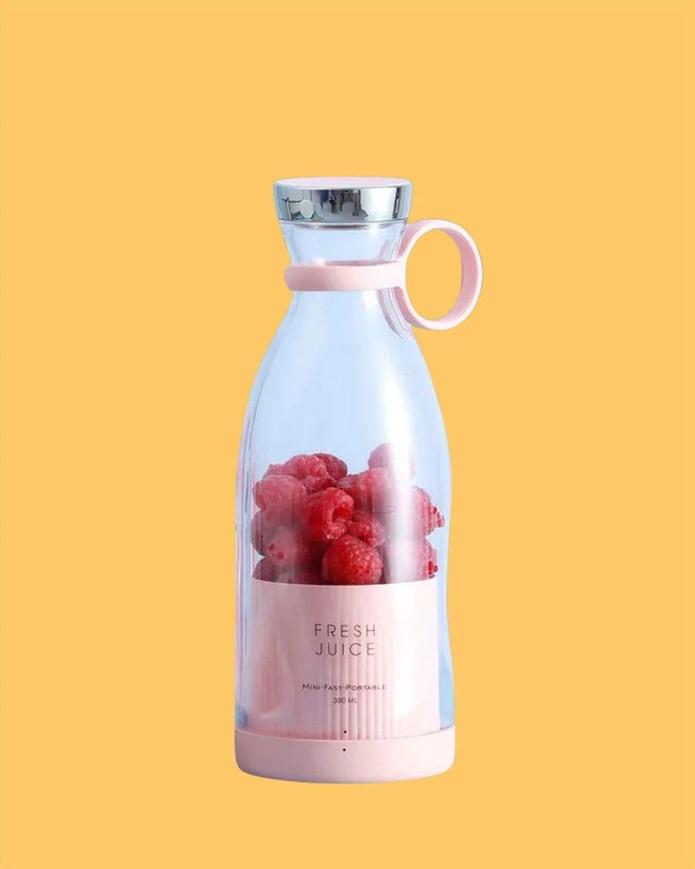 Portable pink blender bottle with raspberries, labeled fresh juice, on yellow background
