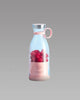Pink portable blender bottle with fresh raspberries labeled 'Fresh Juice' on grey background