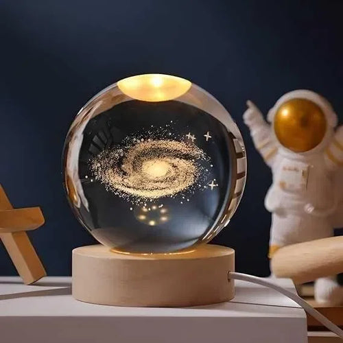 Galaxy crystal ball lamp with wooden base and astronaut figurine, space decor