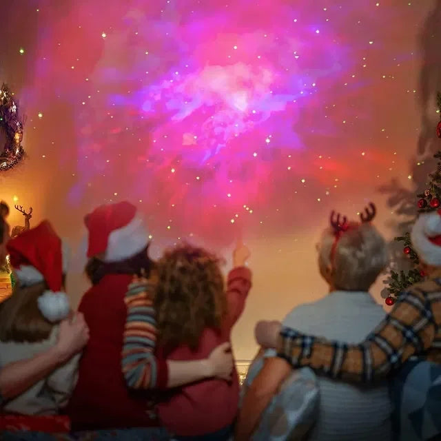 Family in Christmas hats watching colorful galaxy projector near Christmas tree