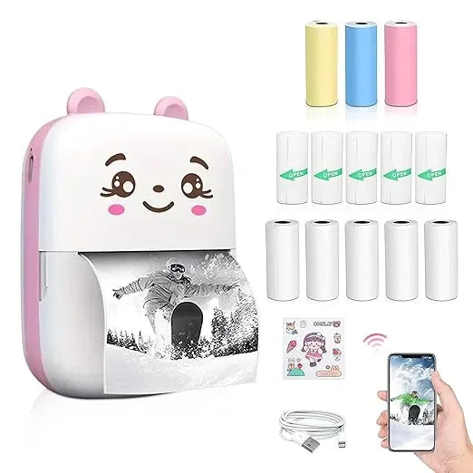 Cute portable thermal printer with cartoon face, printing photo from smartphone, includes paper rolls, USB cable, and stickers.