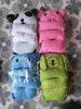 Colorful plush animal pillows including panda, pig, bear, and dog, wrapped in plastic on floral tile