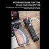 Multifunctional flashlight power bank charging smartphone on desk next to laptop.