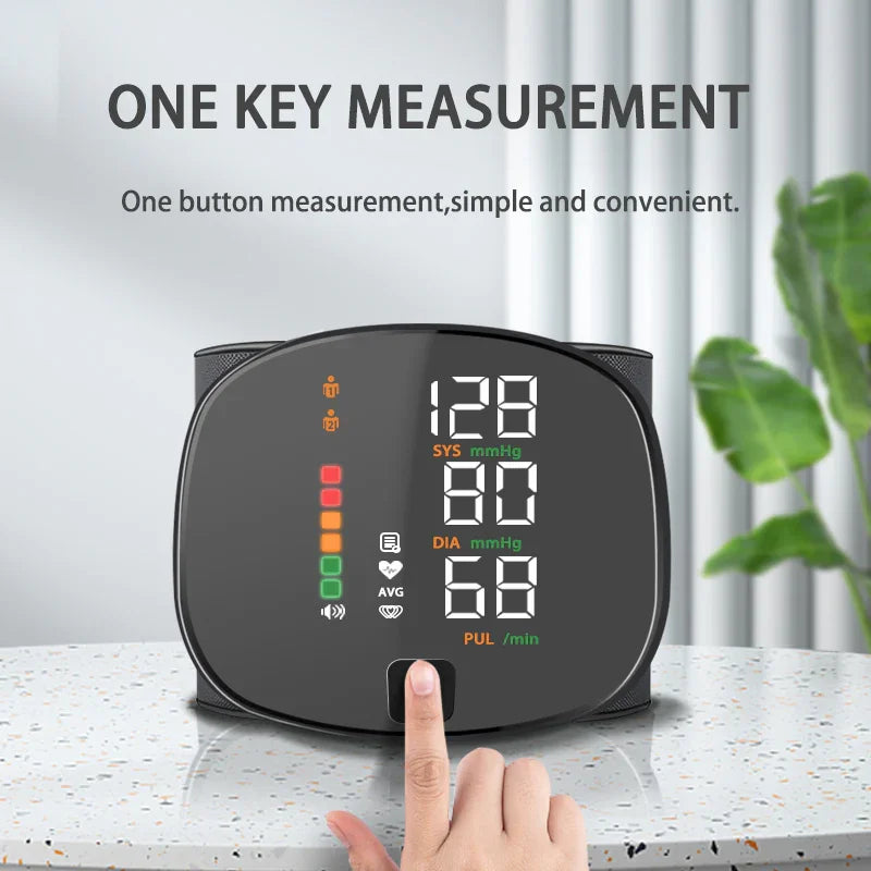 Digital blood pressure monitor with finger pressing start button on marble surface